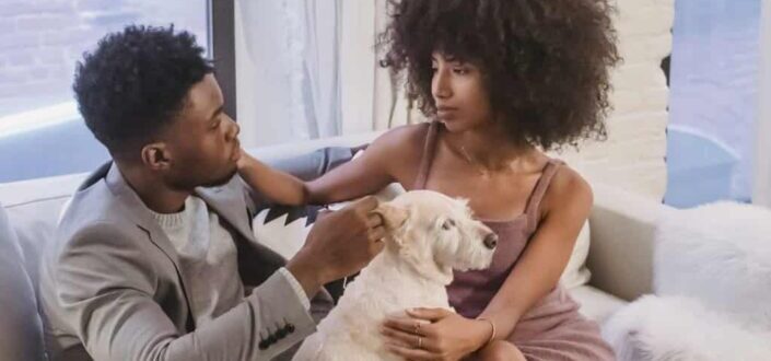 Happy couple with dog at home