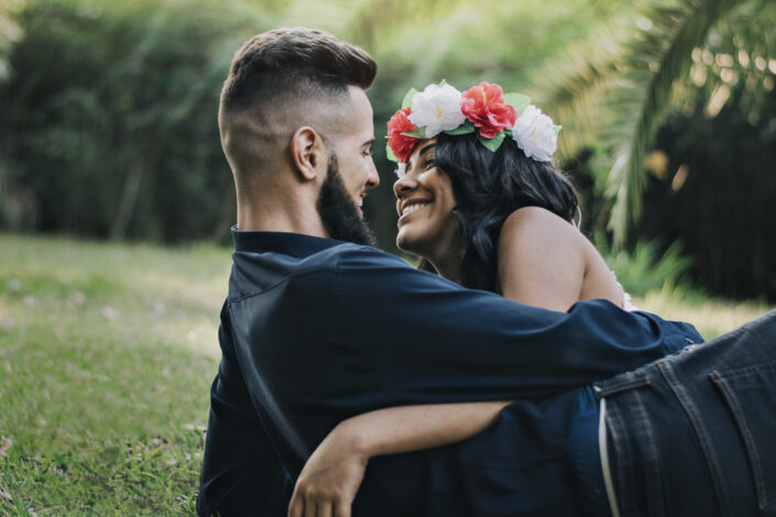 Happy couple hugging on green lawn