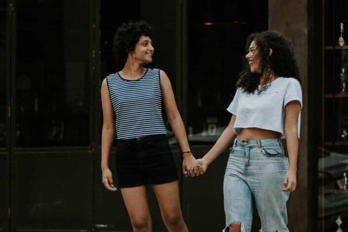 Photo of Two Women Walking on Pedestrian Crossing