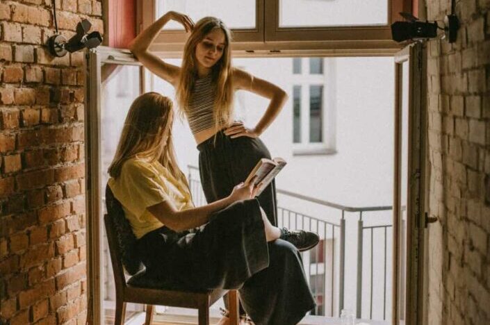 Two Girls Talking in a Room