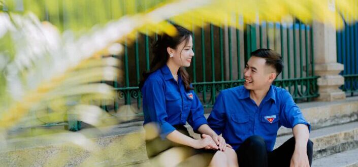A couple sitting while smiling together