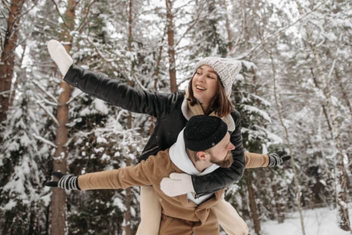 A man carrying a woman on his back