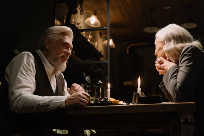 An elderly couple having dinner