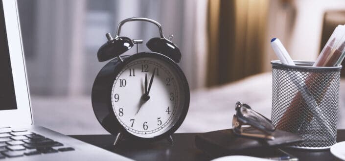 Black twin bell alarm desk clock on table