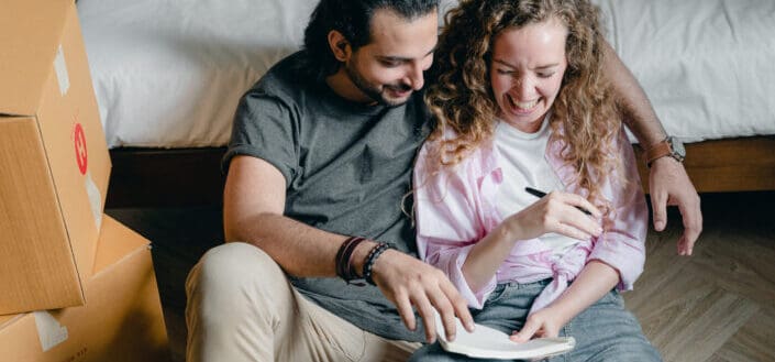 Cheerful couple with notebook 
