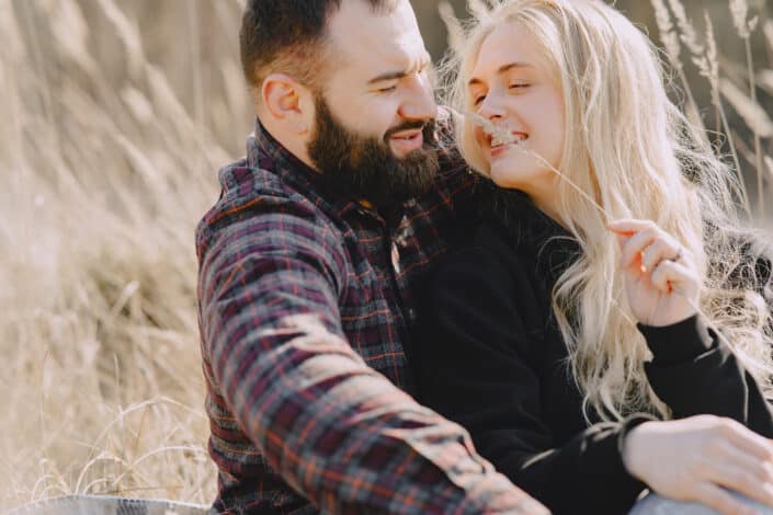 a couple sitting in the field