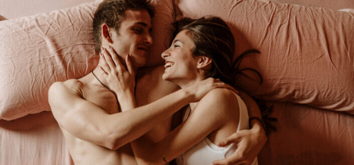 a couple lying down in bed together