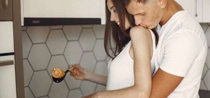 Couple Cooking Corn in the Kitchen