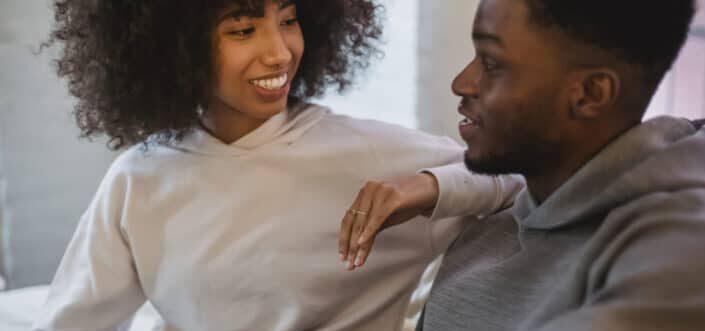 Happy couple communicating in room