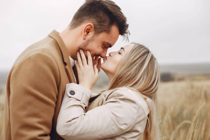 Happy couple embracing in the field