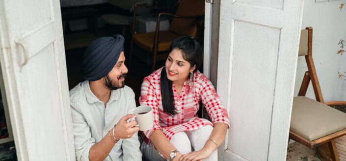 Happy couple talking on veranda