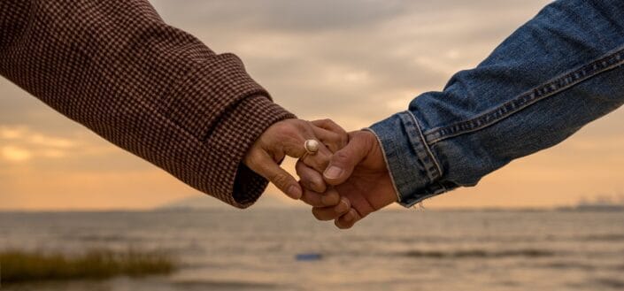 two unidentified persons holding hands