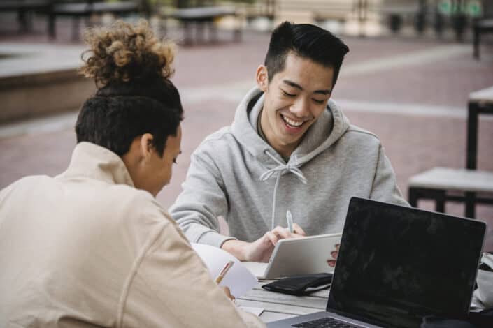 men working on their assignment together