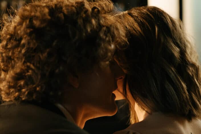 Man Whispering to a Woman
