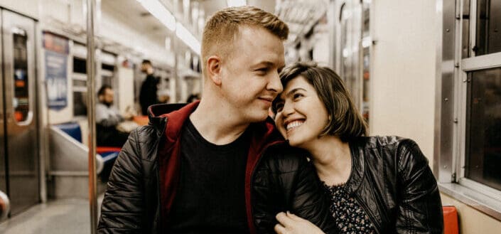 Man and woman sitting inside a train