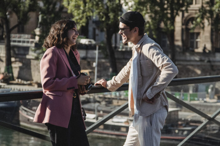 Man and woman standing in front of each other laughing