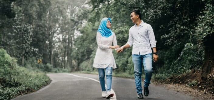 Man and woman walking on road