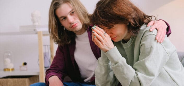 Man comforting crying woman