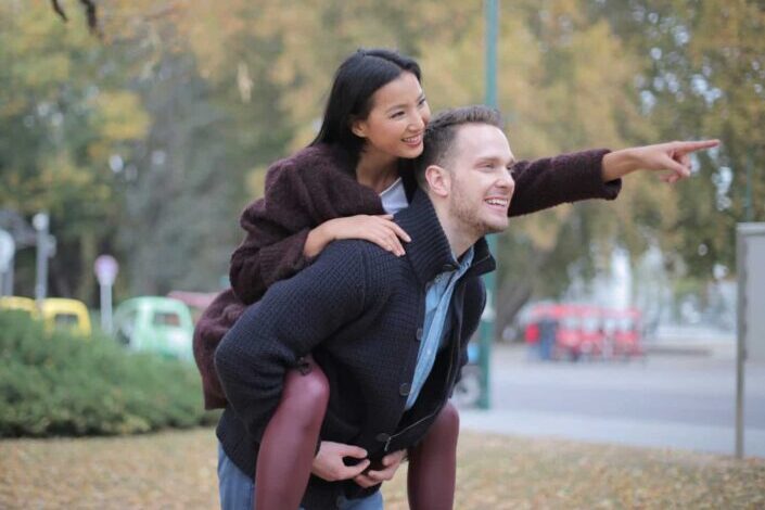 Man giving woman piggyback ride
