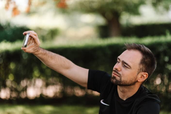Man in black shirt taking selfie