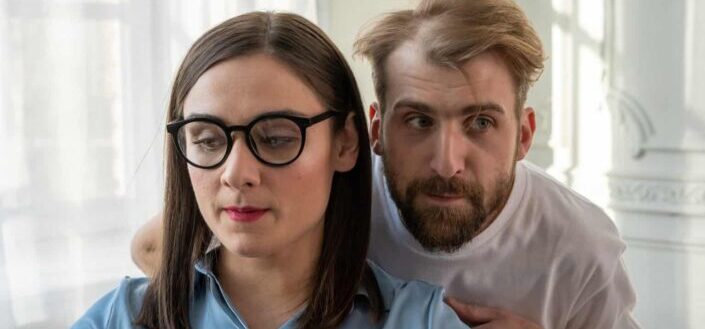 Man in blue polo shirt beside woman in white crew neck t shirt