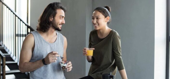 Man and woman holding clear drinking glass