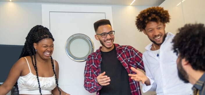 Group of friends happily talking to each in a room