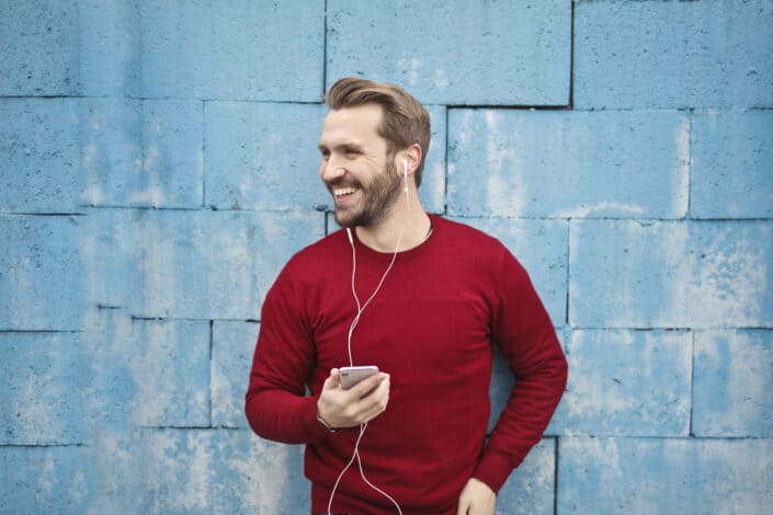 Photo of a man listening music on his phone