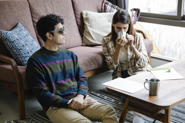 Photo of woman sitting on the ground while drinking coffee