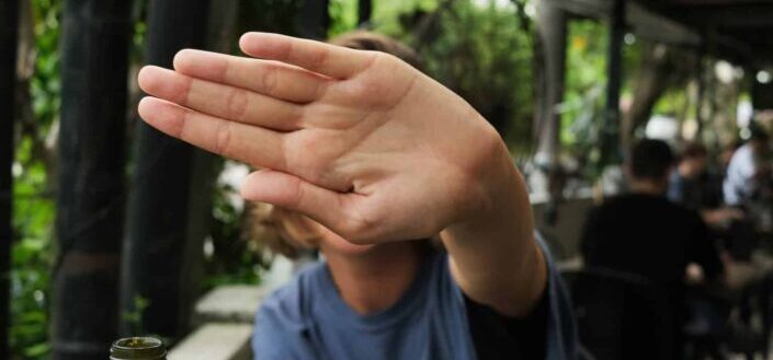 a woman covering her face with her hand