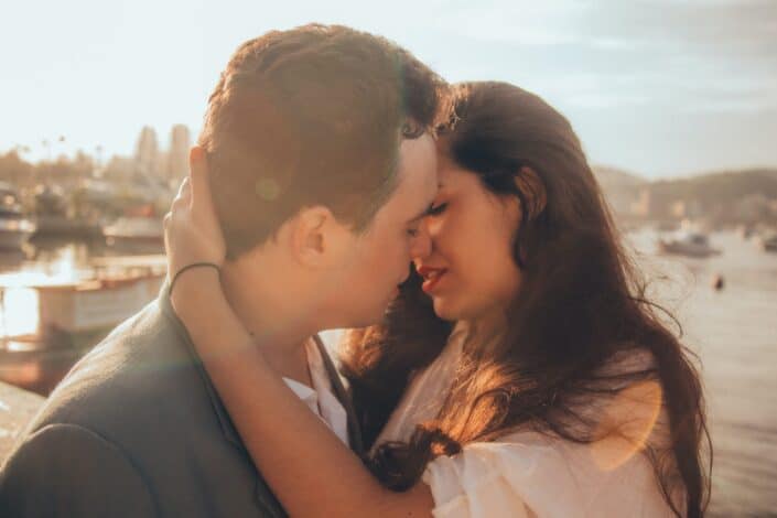 a couple having an intimate moment during sunset
