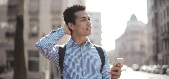 young man using smartphone on street