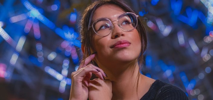 Woman in black shirt wearing eyeglasses