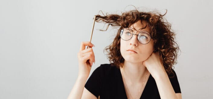 Woman in black v neck shirt wearing eyeglasses