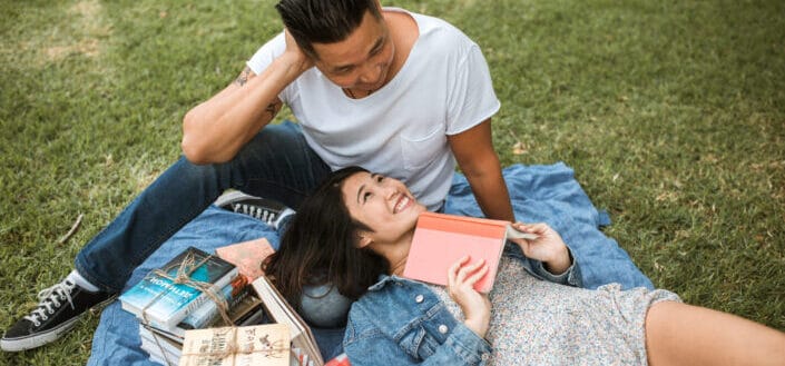 Woman in floral dress lying beside man 