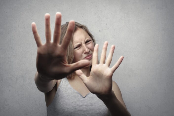 Woman in gray tank top looking frightened