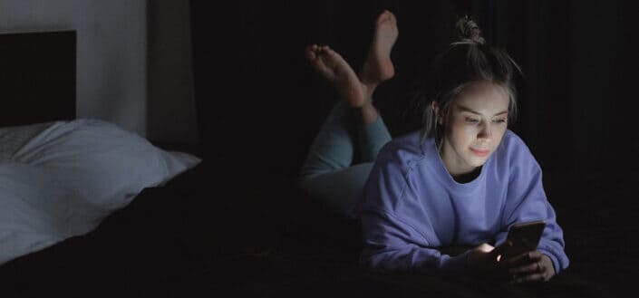 Woman Using a Cellphone in the Dark