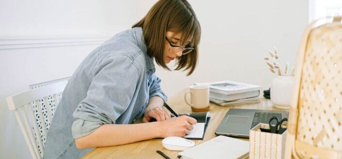 Woman writing on a notebook