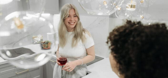 Women talking to each other while in the kitchen