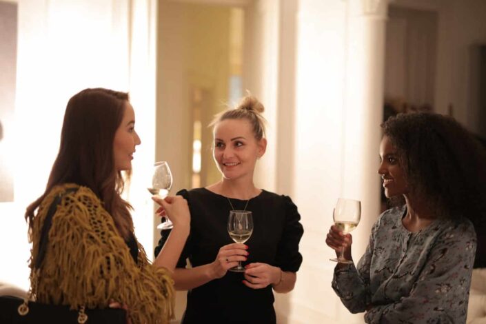 Women Holding Wine Glasses