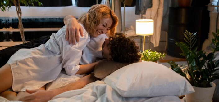 A romantic couple lying on the bed
