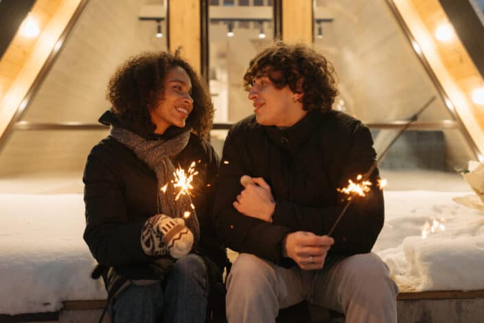 Beautiful couple holding firecrackers