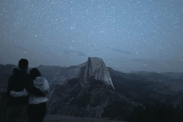Couple hugging while watching the starry sky