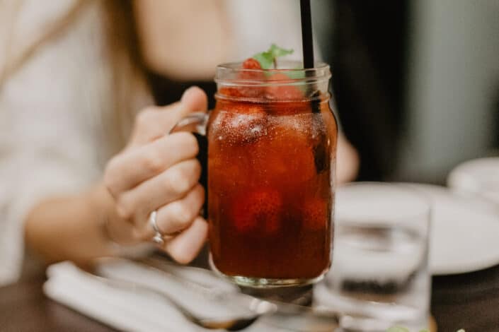 female drinking cold beverage in bar