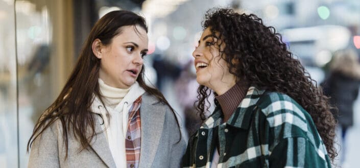 Diverse women discussing showcase on street