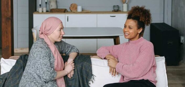 Women Chatting While Sitting on the Couch