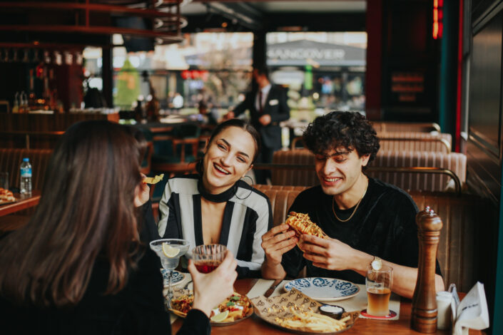 People Eating and Drinking in Restaurant