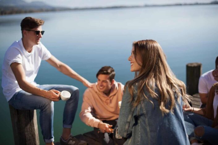 Group of People Sitting on Boat Dock