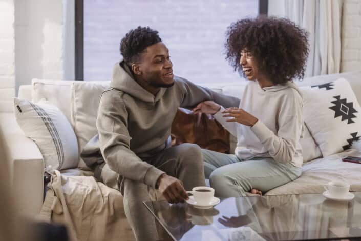Happy black couple smiling at table