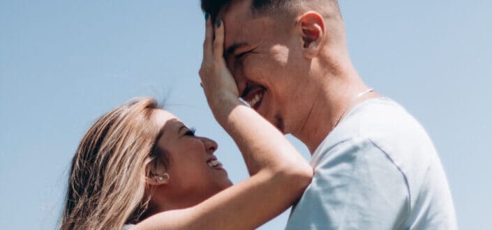 Laughing couple standing and embracing